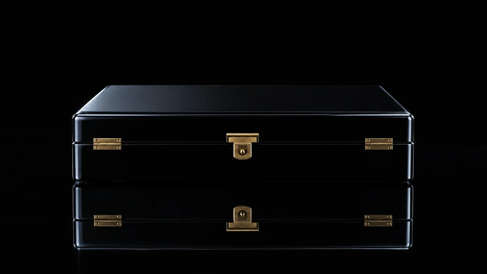 A closed black lacquered gift box with brass hinges on a glossy black surface