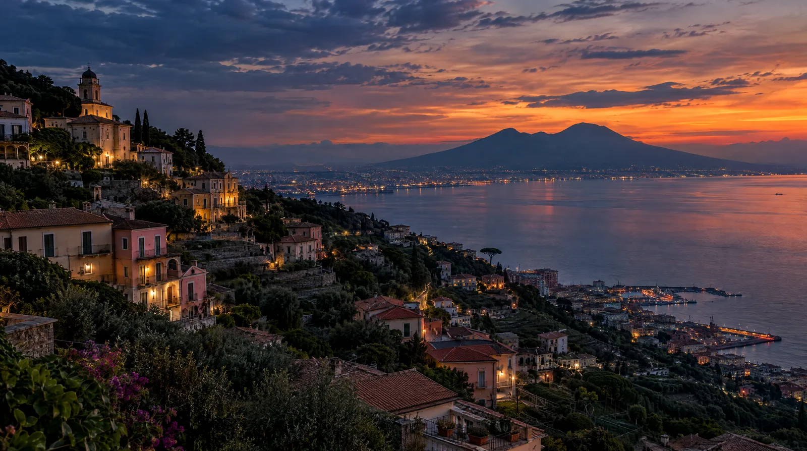 The hillside town of Gragnano above the Bay of Naples at dusk, Vesuvius beyond